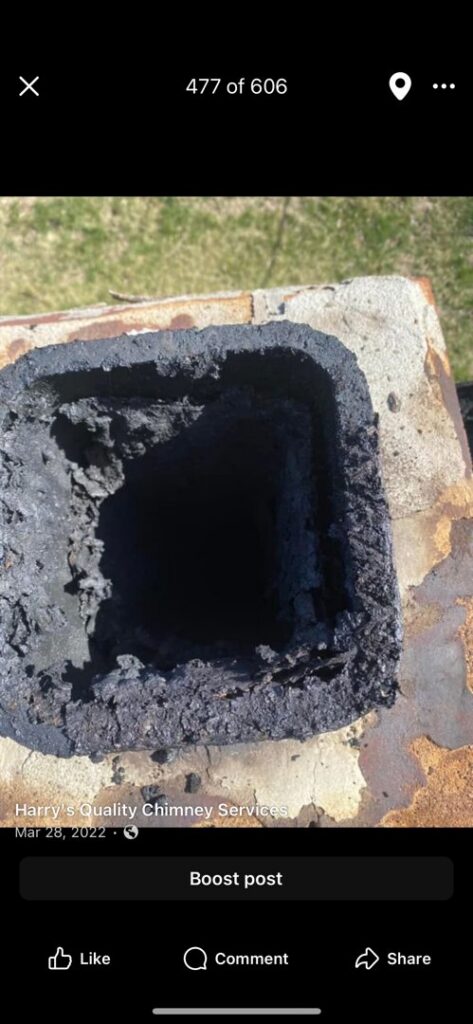 A close-up view of heavy creosote buildup inside a chimney flue, indicating a need for chimney sweeping by Harry's Quality Chimney Services in Kansas City, MO