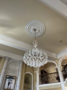 A grand crystal chandelier expertly installed in a high-ceiling room by Innovate Electric in Earth City, MO.