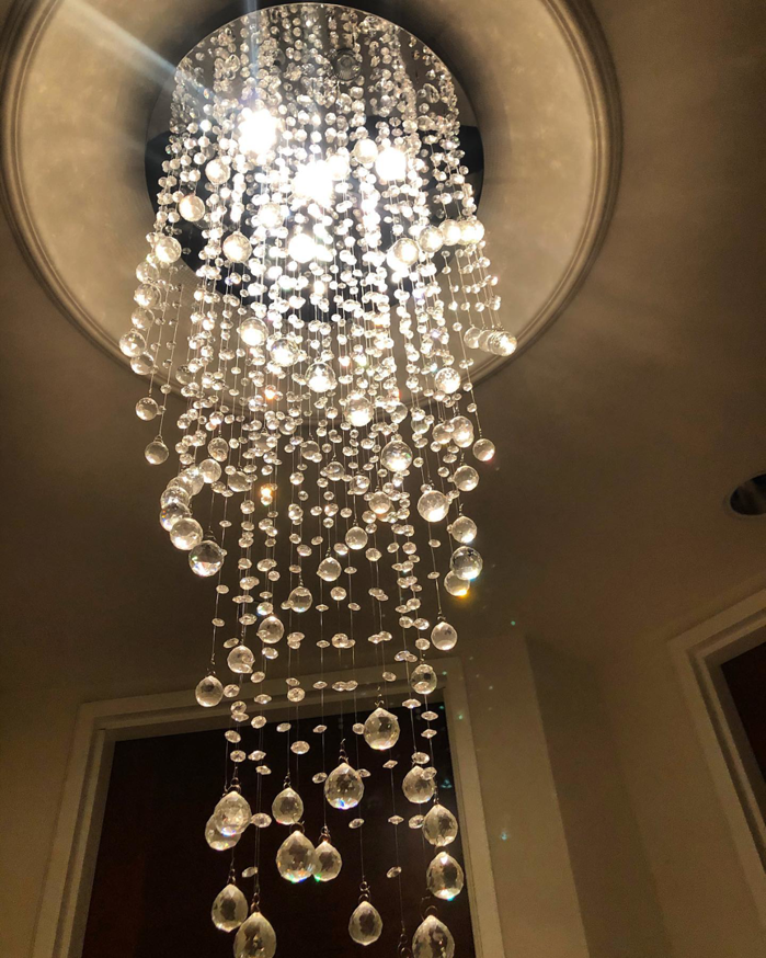 A large, elegant crystal chandelier professionally installed by Obot Electric in Bellevue, WA
