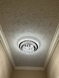 Crystal flush-mount light fixture installed on a textured ceiling by Perfection Lighting, Design, and Installations in Atlanta, GA.