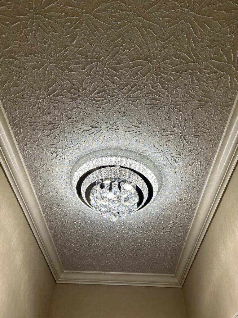 Crystal flush-mount light fixture installed on a textured ceiling by Perfection Lighting, Design, and Installations in Atlanta, GA.