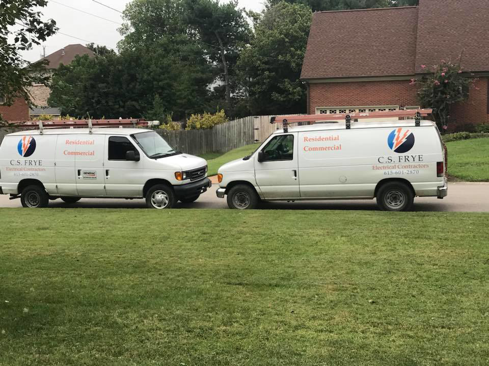 Two C.S. FRYE Electrical Contractors service vans parked, ready for residential and commercial jobs in Franklin, TN