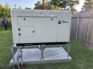 A large Cummins generator professionally installed on a concrete pad in a residential backyard by Craig's Electrical and Generator Service in Kenner, LA.