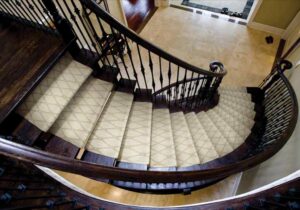 Elegant light-colored patterned carpet runner installed on a curved staircase by Custom Crafted Floors in Phoenix, AZ.