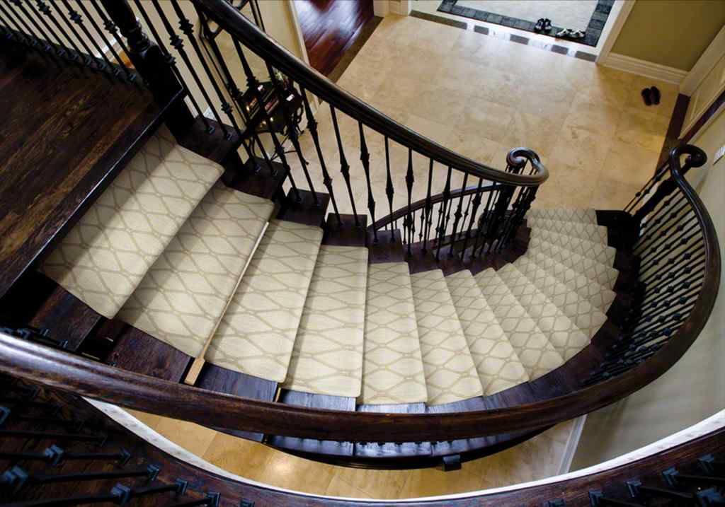 Elegant light-colored patterned carpet runner installed on a curved staircase by Custom Crafted Floors in Phoenix, AZ.