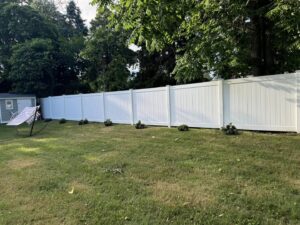 Curved white vinyl privacy fence installed in a residential backyard by Select Fence & Guardrail in North Haven, CT.