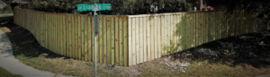 A long, curved wooden privacy fence installed on a corner residential lot by G Squared Fencing & Services LLC in New Braunfels, TX.