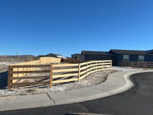 A newly installed curved wooden split-rail fence around a residential property by All Over Fence Idaho in Jerome, ID