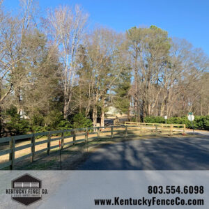A curving new light-colored wooden fence installed along a roadside by Kentucky Fence Co in McConnells, SC.