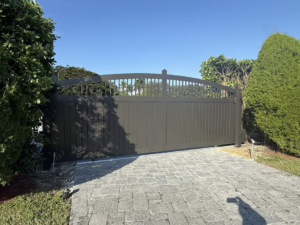 A custom-designed arched driveway gate installed by A Master Work Corp. in Hialeah, FL.