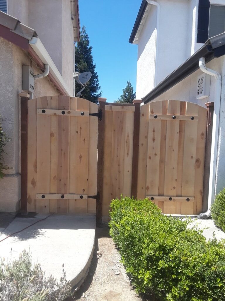 Custom arched wooden gates providing a residential entry installed by Angel Fencing Inc. in Fresno, CA