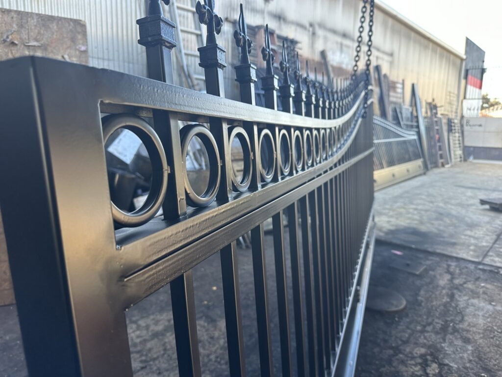 A close-up view of a custom black iron gate section being fabricated by Exclusive Custom Iron Works in Stockton, CA.