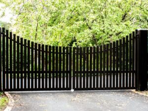 A custom black wood driveway gate, expertly installed by OneGuard Fencing in Vestavia Hills, AL.