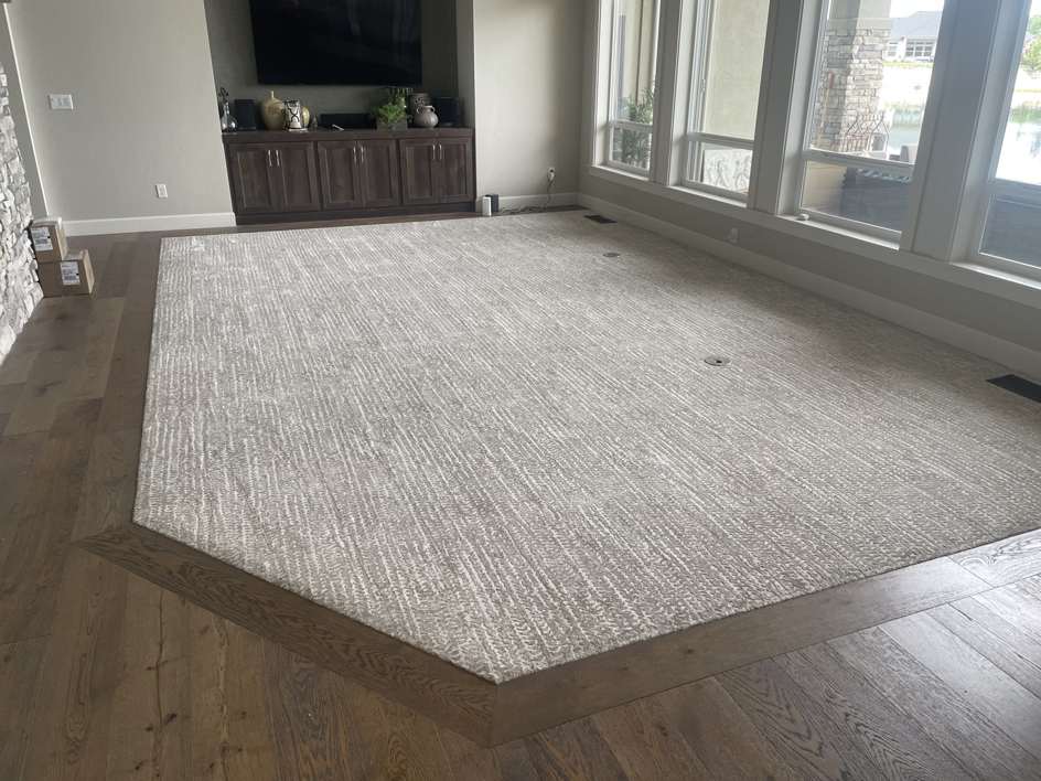 A custom-shaped carpet installed in a living room by Alpine Floor Covering in Nampa, ID.