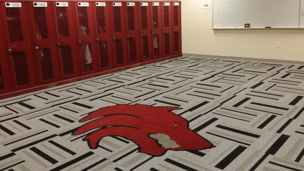 Custom carpet installation featuring a red wolf head logo and geometric pattern by ReSource Arizona in Phoenix, AZ