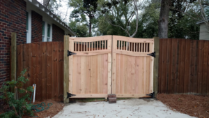 Custom double wooden gates with a matching fence installed by Fence & Custom Gatework LLC in Columbia, SC