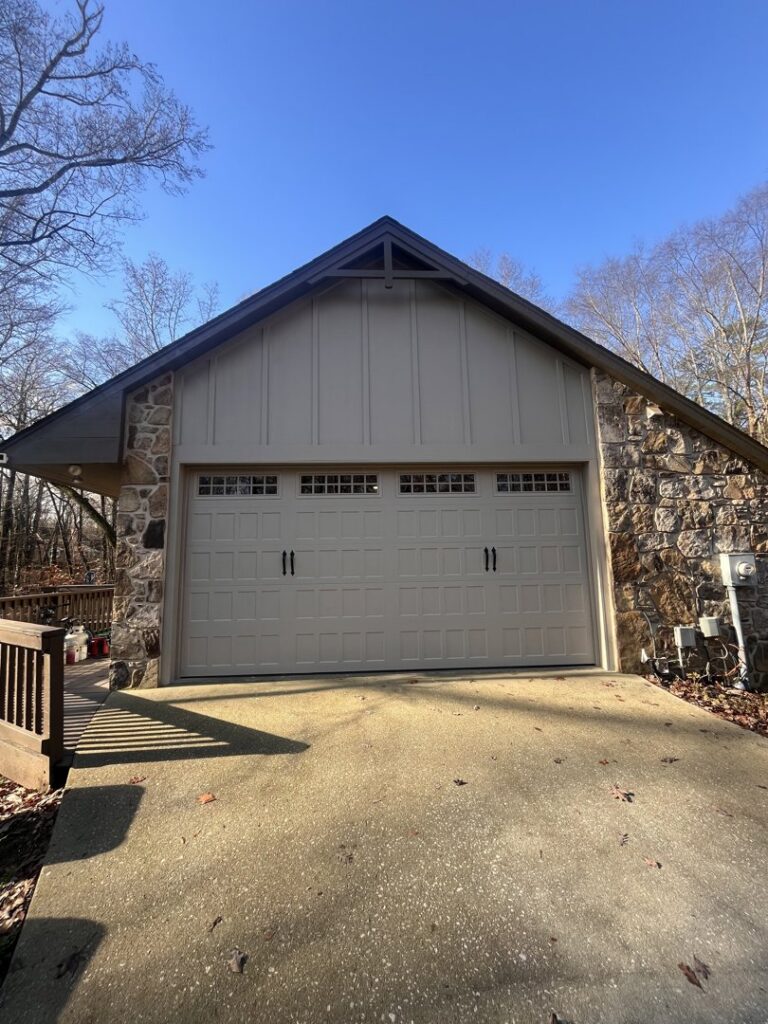 A custom light-colored garage door with decorative windows and handles, expertly installed by Knox Garage Door Service LLC in Knoxville, TN.