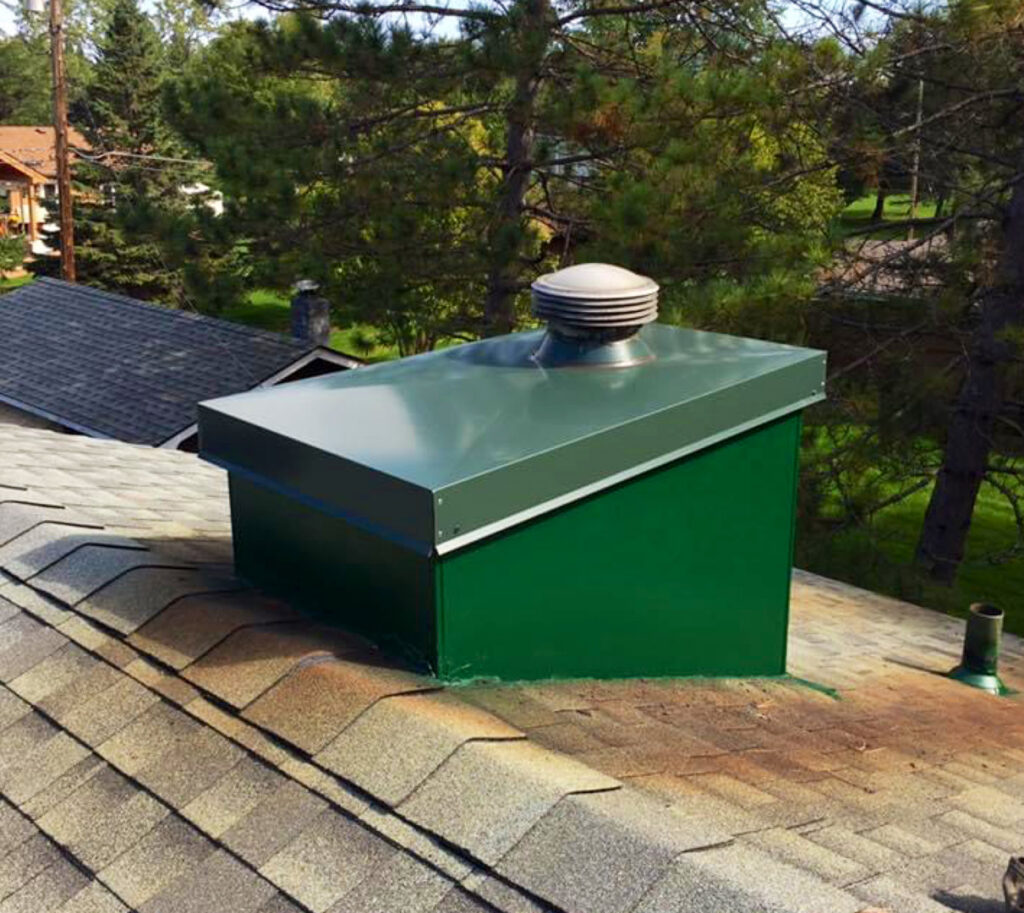 Custom green metal chimney cap and vent installation by Sheet Metal Solutions, LLC in Duluth, MN.