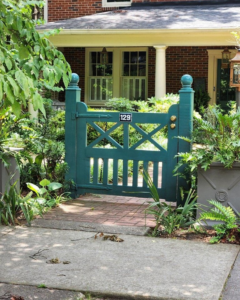 A custom green wooden gate with an address number installed by Fence & Custom Gatework LLC in Columbia, SC