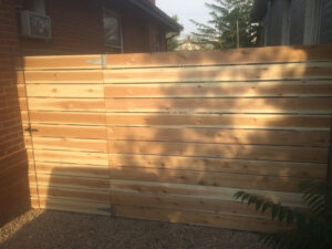 A custom horizontal slat fence with an integrated gate, installed by Accent Fence & Design in Lakewood, CO.