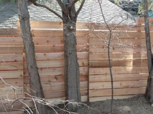 A custom-built horizontal wood fence installed by Done Wright Fencing and Welding in Denver, CO.