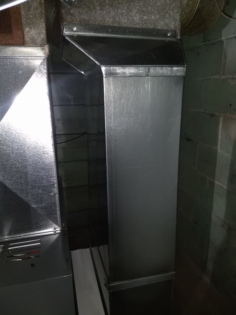 Detailed view of custom sheet metal HVAC ductwork installed by PM Construction in Loves Park, IL.