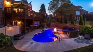 A custom inground pool with LED lighting and a fire pit, installed by Firemaster in Oklahoma City, OK