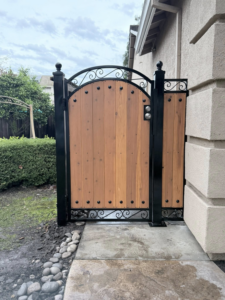 A newly installed custom iron and wood pedestrian gate by Exclusive Custom Iron Works in Stockton, CA.