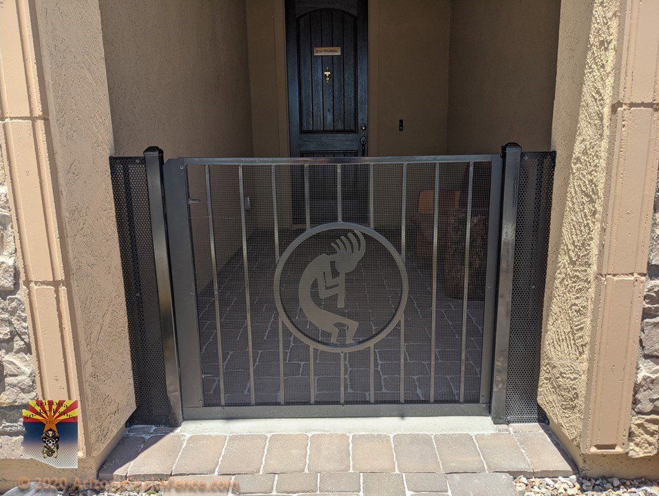 A custom metal gate featuring a Kokopelli design, installed by Arizona Snake Fence LLC as part of a fencing project in Tucson, AZ