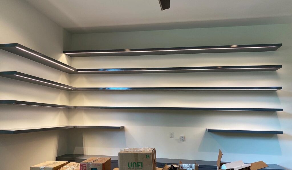 Custom shelves with integrated LED strip lighting, installed by Molitor Electric, providing modern illumination in Austin, TX.