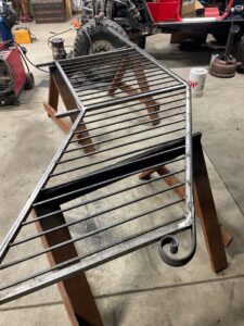 A custom metal gate section with a decorative scroll being fabricated by Integrity Gates and Fencing in Yakima, WA