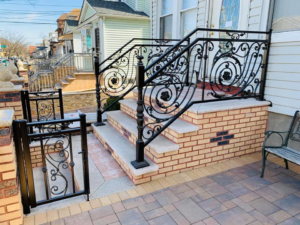 Custom ornamental metal railing and a small gate for steps by Elite Ornamental Fence LLC in Paterson, NJ.