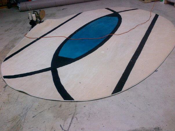 Custom oval-shaped rug with a modern design being created by Palmetto Carpet Company in Miami, FL.