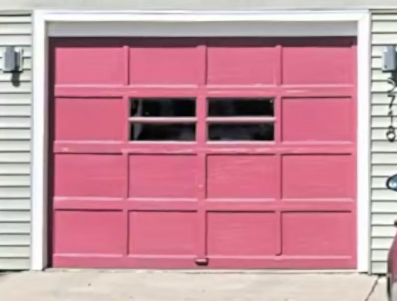 A custom pink garage door with windows, showcasing a unique installation by Max Garage Door in Minneapolis, MN.