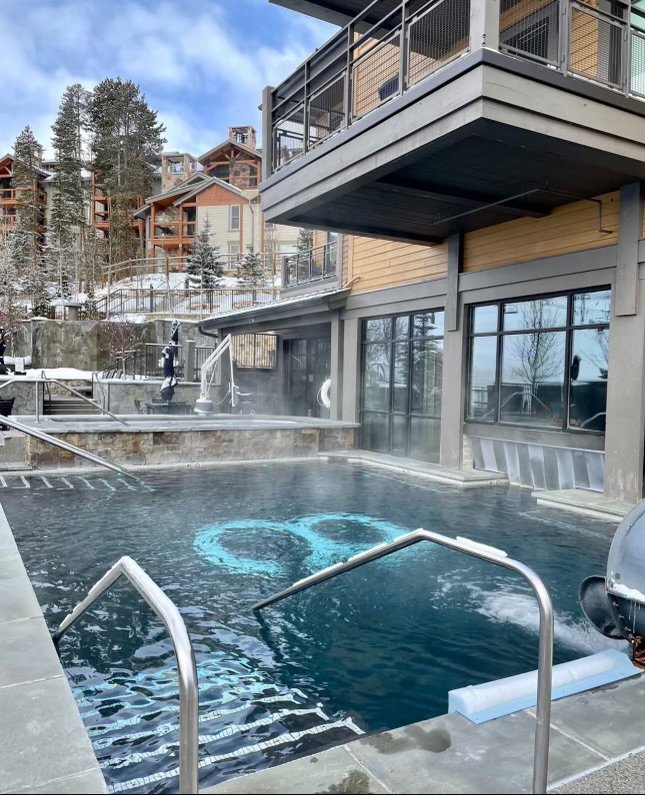 A custom-designed pool featuring an infinity symbol at the bottom, a project by Wetworks Pool and Spa in Englewood, CO.