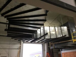 Intricate custom spiral HVAC ductwork installation in a commercial space by Central Consolidated in Wichita, KS