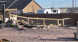 A custom wire mesh and wood enclosure, expertly built by Fence Tech in Everett, WA, for a backyard feature.