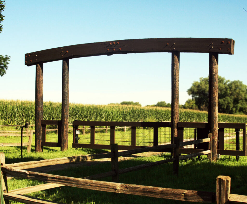 A custom wood fence entrance structure installed by American Fence Company of Columbus in Grand Island, NE.
