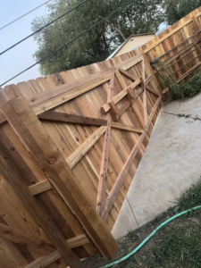 A custom-built wooden gate with diagonal bracing by HG Fencing LLC in Fountain, CO.