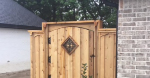 A custom-built wooden gate and fence panel installed by Ozark Mountain Fence & Construction in Fayetteville, AR.