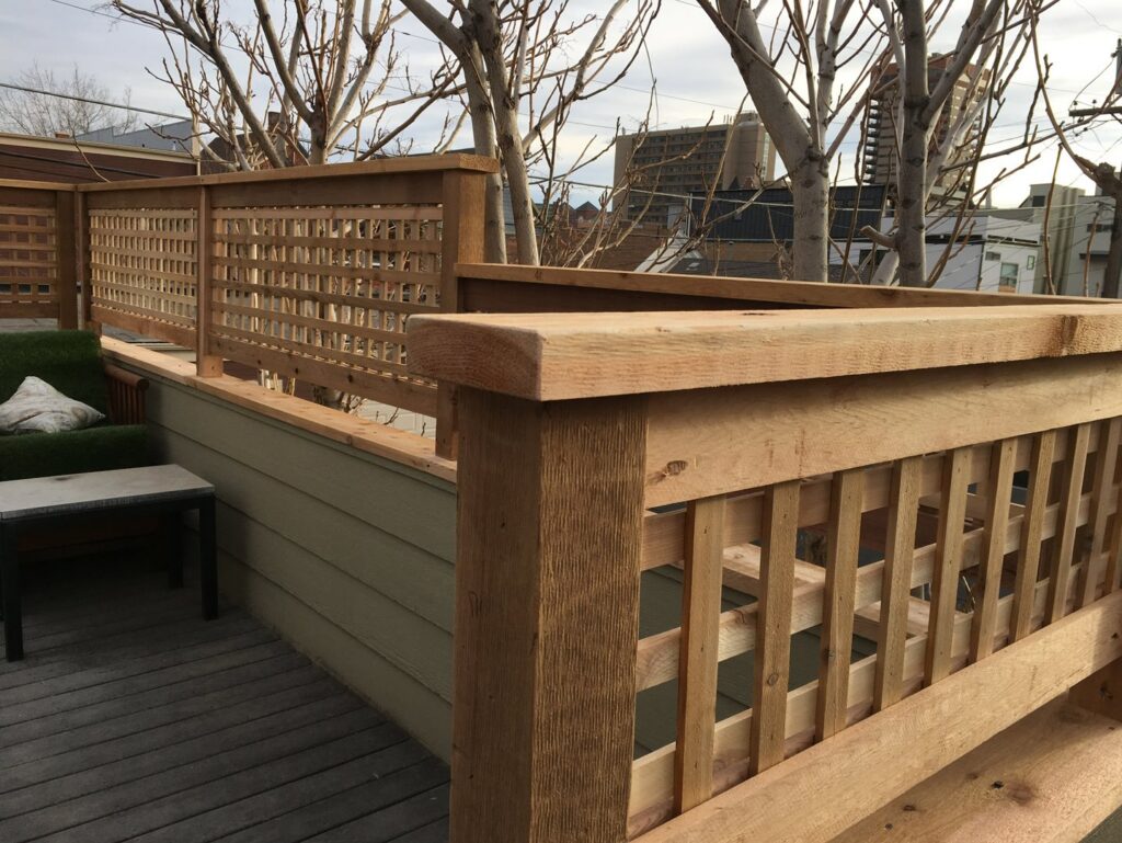 Custom wooden lattice railing installed on a deck or rooftop by Accent Fence & Design in Lakewood, CO.