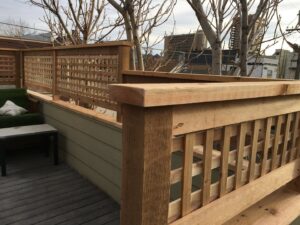 Custom wooden lattice railing installed on a deck or rooftop by Accent Fence & Design in Lakewood, CO.