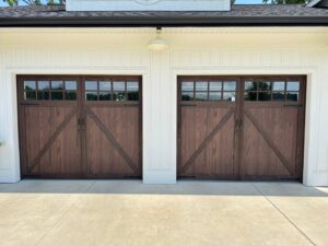 Custom wood-look garage doors with decorative hardware installed by Platinum Garage Door Services in Helena, AL