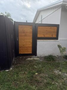A custom wood and metal pedestrian gate providing access to a property by A Master Work Corp. in Hialeah, FL.