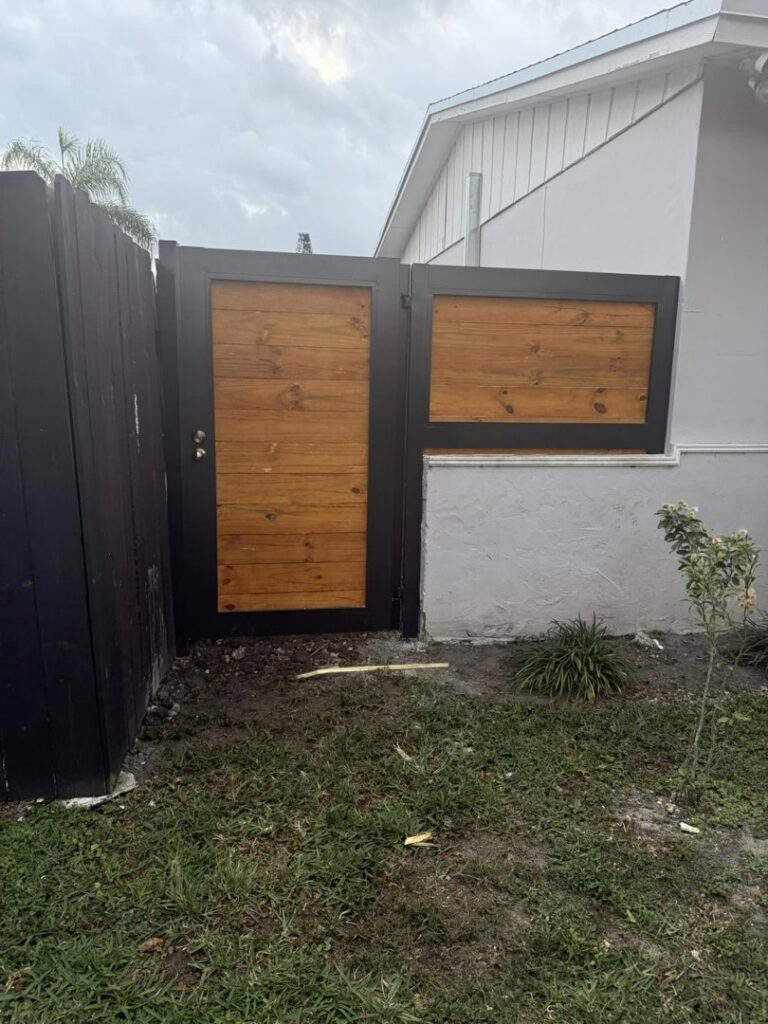 A custom wood and metal pedestrian gate providing access to a property by A Master Work Corp. in Hialeah, FL.