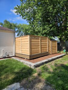 A custom wood privacy fence enclosing an outdoor area, expertly installed by JM Fence Works in Davenport, IA.