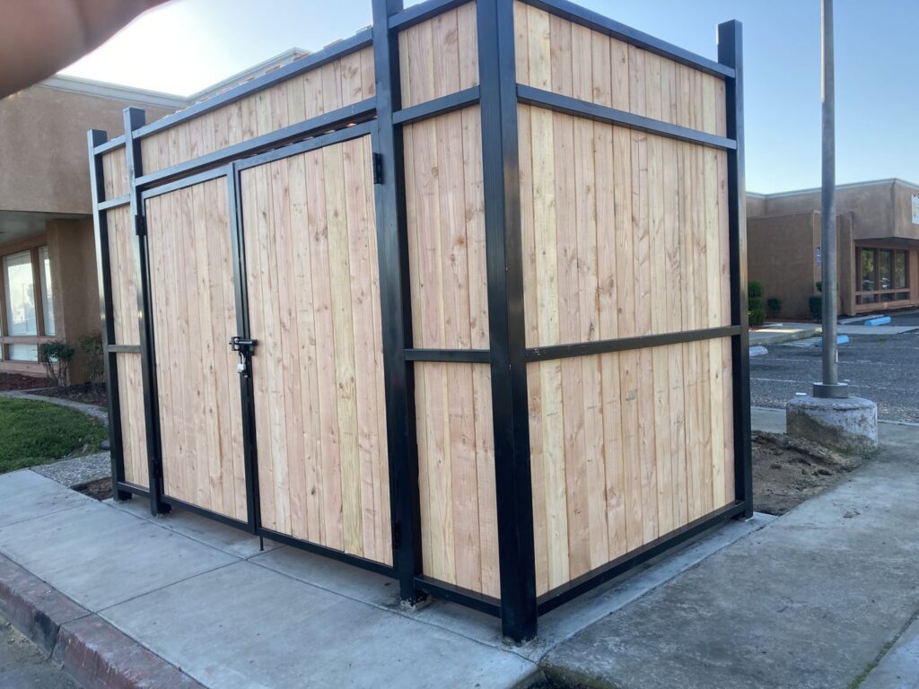 A custom wooden enclosure with a durable iron frame, built by Exclusive Custom Iron Works in Stockton, CA.