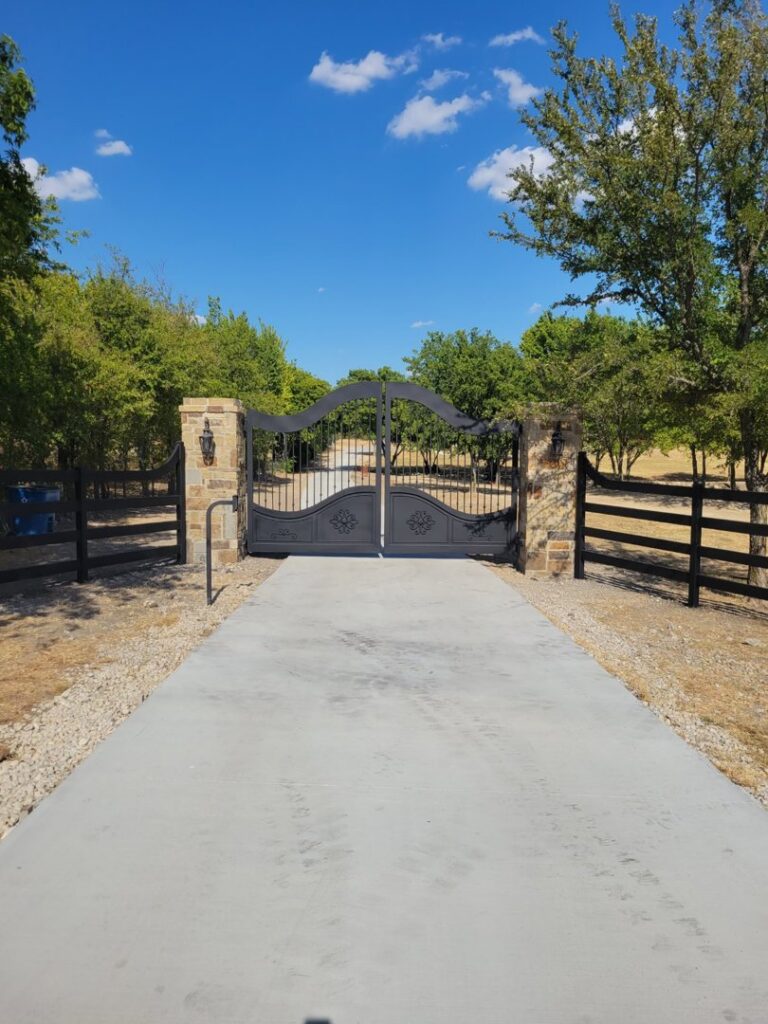 A close-up of a custom wooden gate with decorative metal handle and accents by Ft Worth Fence And Patio in Fort Worth, TX.