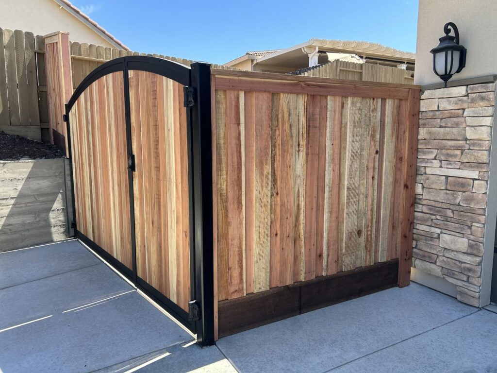 A custom wooden gate with a sturdy metal frame installed at a residential property by Horizon Fence & Custom Gates, Inc. in Orangevale, CA.