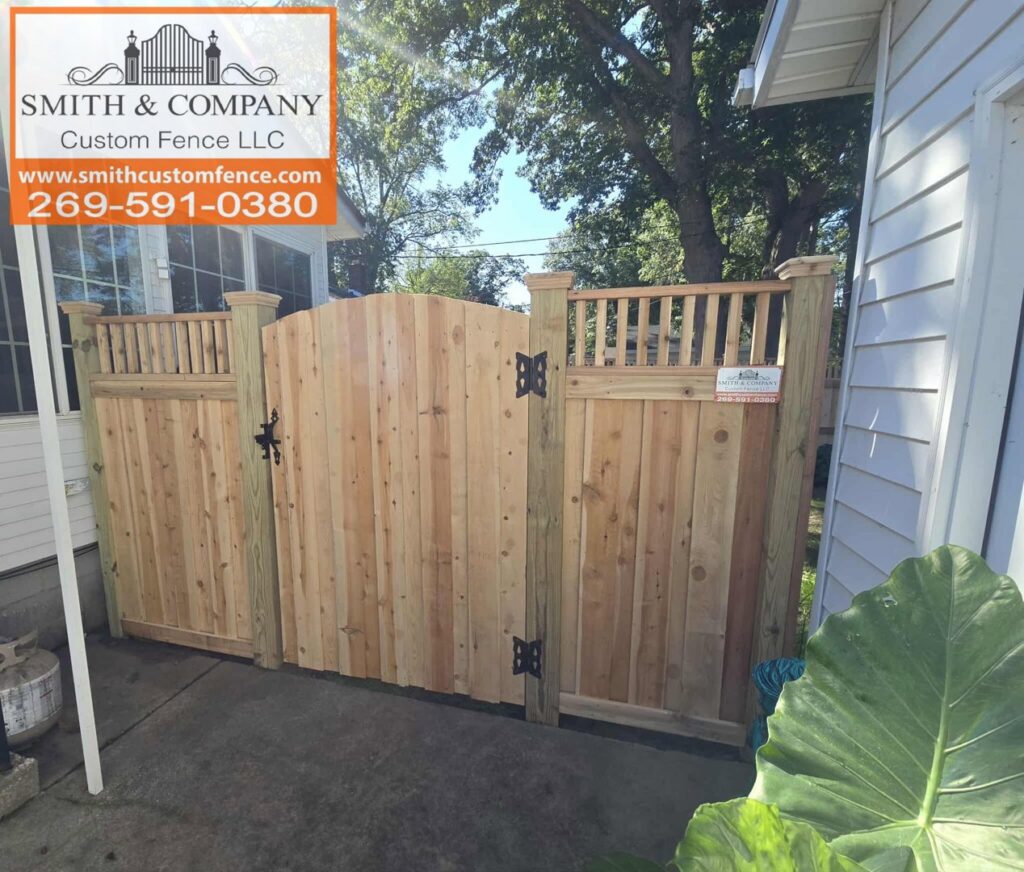 A custom wooden gate with a decorative lattice top section, installed by Smith & Company Custom Fence LLC in Niles, MI.